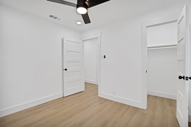 unfurnished bedroom with light wood-type flooring, a closet, and ceiling fan