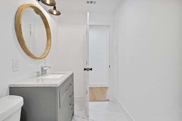 bathroom with vanity and toilet