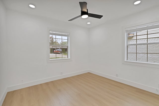 empty room featuring ceiling fan and light hardwood / wood-style floors