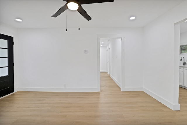 interior space with ceiling fan, light hardwood / wood-style floors, and sink