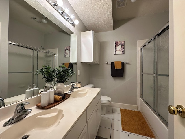 full bathroom featuring vanity, tile patterned flooring, toilet, enclosed tub / shower combo, and a textured ceiling