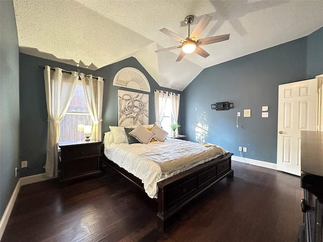 bedroom featuring a textured ceiling, multiple windows, ceiling fan, and dark hardwood / wood-style floors