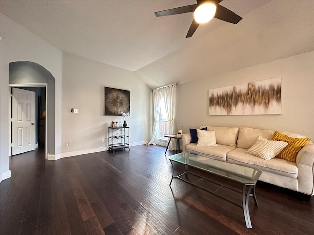 living room with ceiling fan, dark hardwood / wood-style flooring, and lofted ceiling