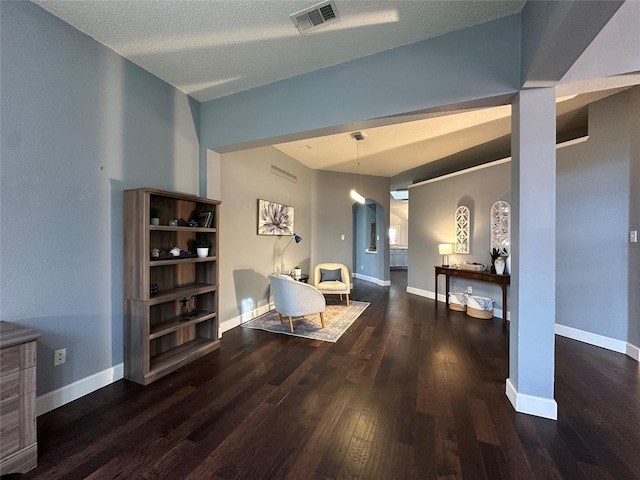 sitting room with a textured ceiling and dark hardwood / wood-style floors