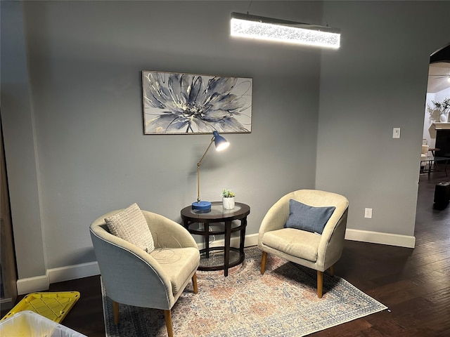 sitting room featuring dark wood-type flooring