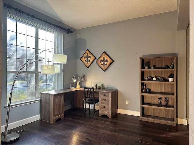 home office with a textured ceiling, dark hardwood / wood-style floors, and a healthy amount of sunlight