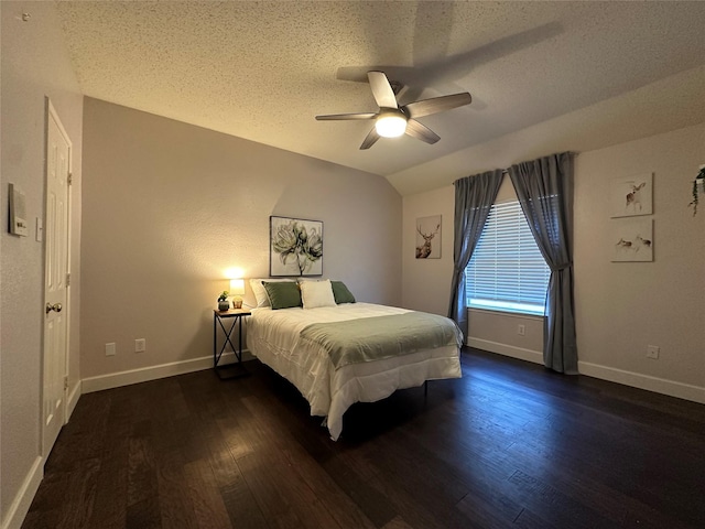 bedroom featuring a textured ceiling, ceiling fan, dark hardwood / wood-style flooring, and vaulted ceiling