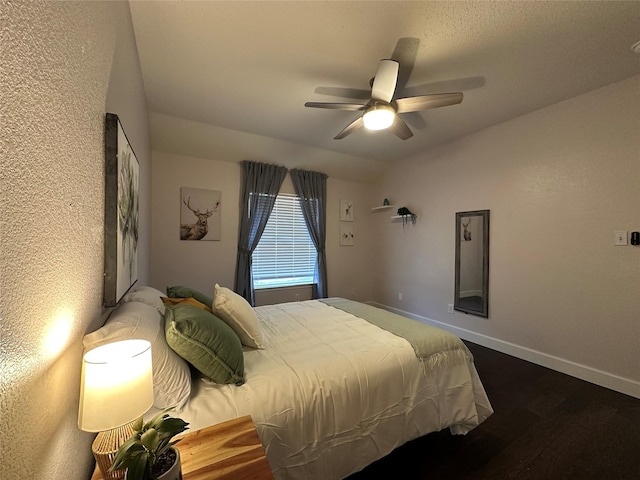 bedroom with ceiling fan and dark wood-type flooring