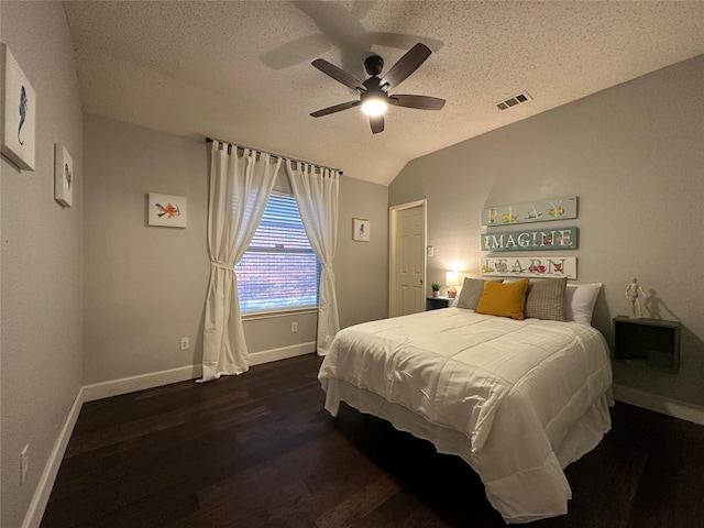 bedroom featuring a textured ceiling, ceiling fan, dark hardwood / wood-style flooring, and lofted ceiling