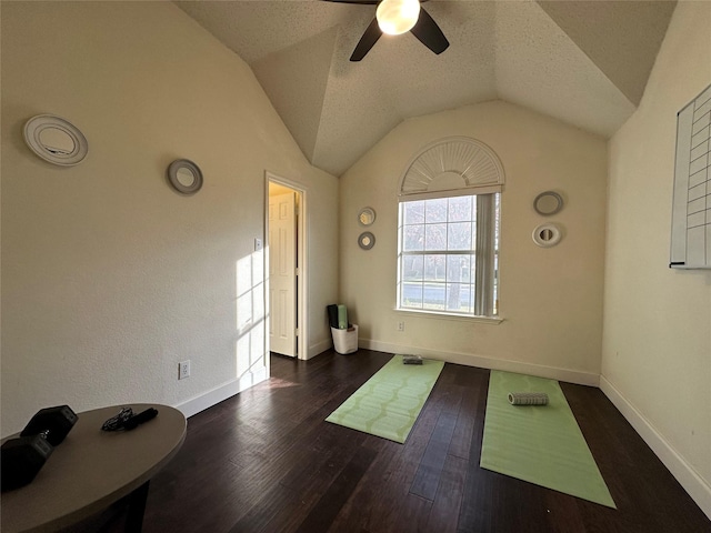 interior space with a textured ceiling, dark hardwood / wood-style flooring, ceiling fan, and lofted ceiling