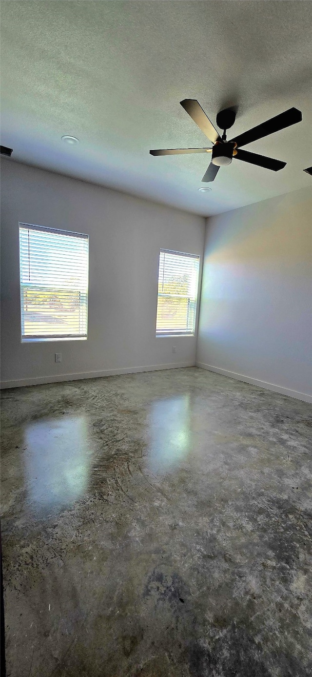 unfurnished room featuring concrete flooring and a textured ceiling