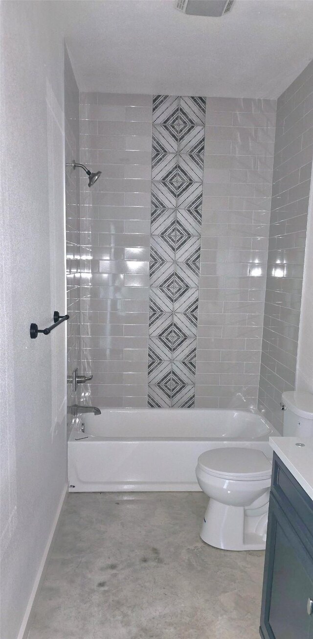 full bathroom with vanity, toilet, and tiled shower / bath combo