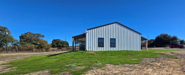 view of side of property with a yard