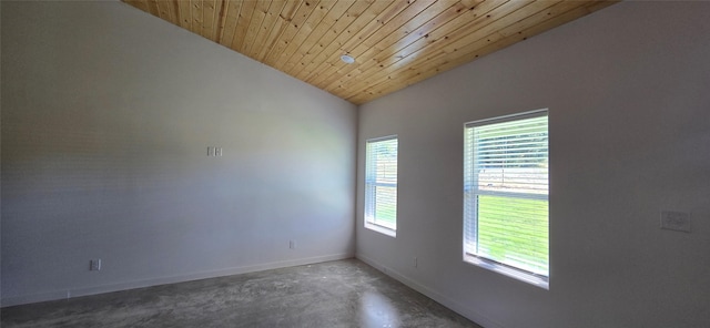 empty room with wooden ceiling and vaulted ceiling