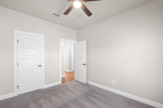 unfurnished bedroom featuring light carpet and ceiling fan