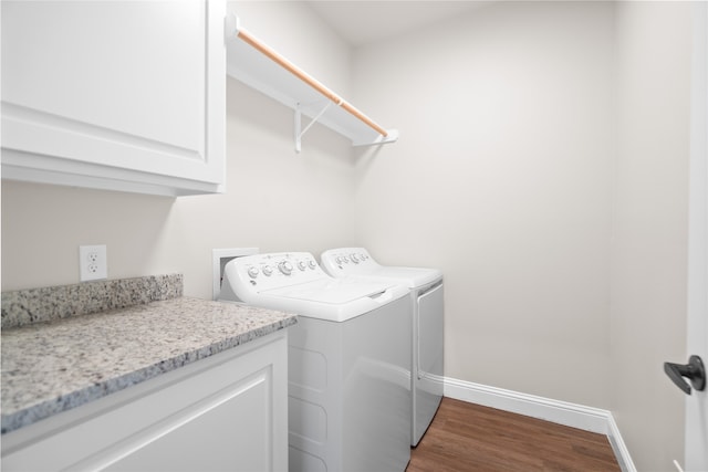 laundry area featuring cabinets, dark hardwood / wood-style flooring, and separate washer and dryer