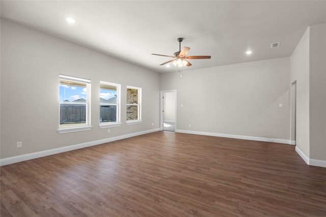 spare room featuring dark hardwood / wood-style flooring and ceiling fan