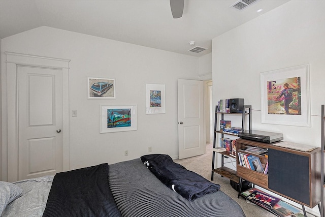 bedroom with lofted ceiling, light carpet, and visible vents