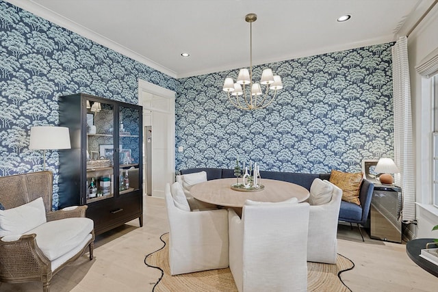 dining area with recessed lighting, crown molding, an inviting chandelier, and wallpapered walls