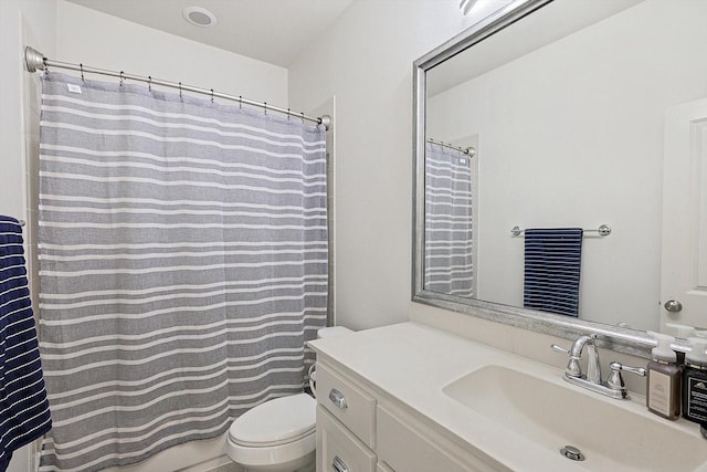 full bath featuring toilet, a shower with shower curtain, and vanity