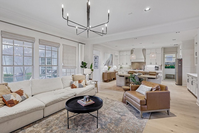 living area featuring a chandelier, crown molding, light wood-type flooring, and recessed lighting