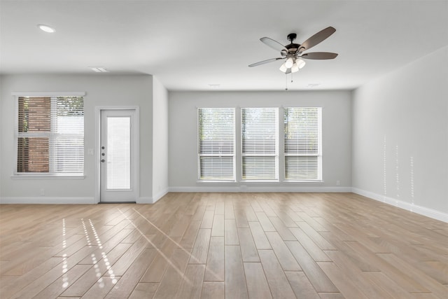 unfurnished room with light hardwood / wood-style flooring and ceiling fan