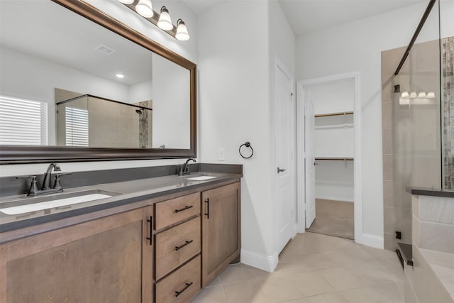 bathroom with vanity, a shower with shower door, and tile patterned flooring