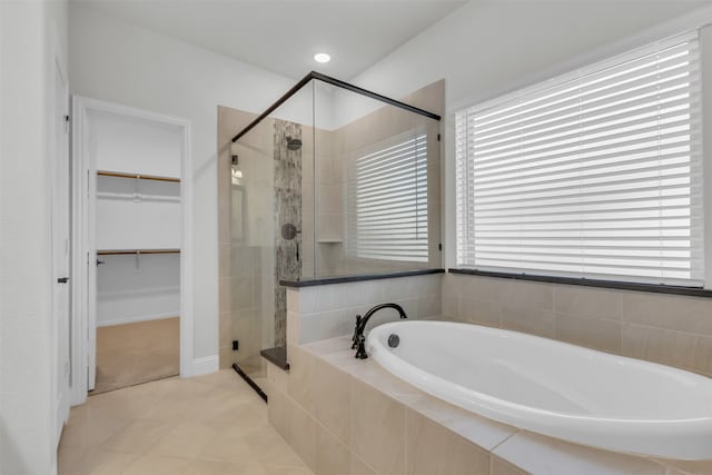 bathroom featuring separate shower and tub and tile patterned flooring