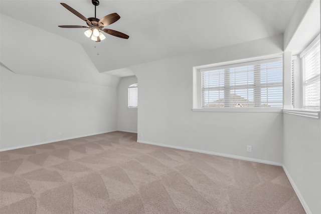 bonus room featuring lofted ceiling, light carpet, and ceiling fan