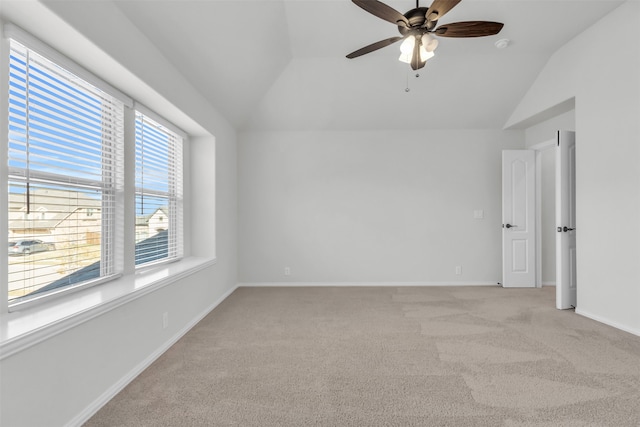 unfurnished room featuring ceiling fan, light colored carpet, and vaulted ceiling