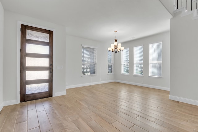 foyer featuring light hardwood / wood-style floors and a notable chandelier