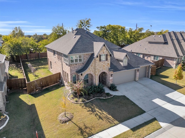 view of front of property with a garage and a front lawn