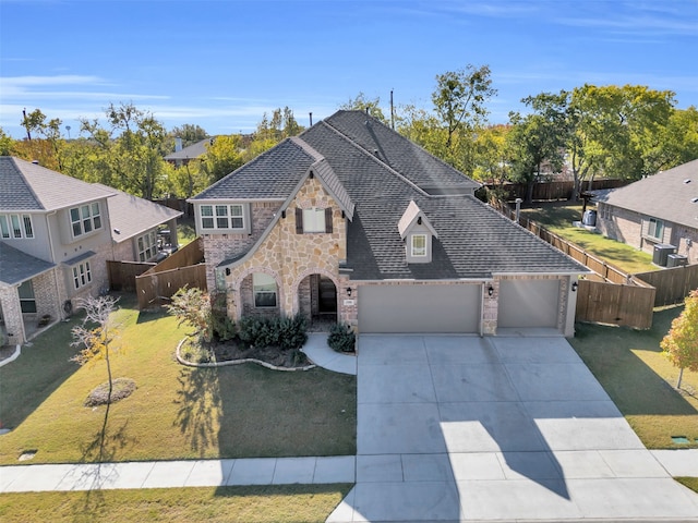 view of front of home with a garage and a front lawn