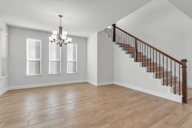 interior space featuring an inviting chandelier and light hardwood / wood-style flooring