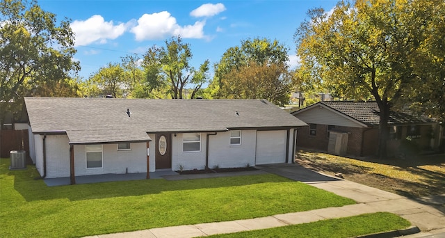 ranch-style home featuring central AC, a garage, and a front lawn