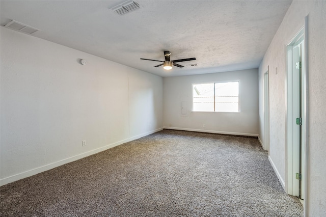 carpeted spare room with a textured ceiling and ceiling fan