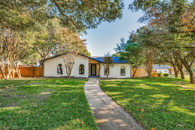 ranch-style home with a front yard