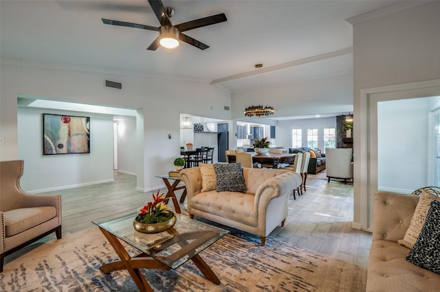 living room featuring crown molding, lofted ceiling, ceiling fan, and light hardwood / wood-style floors