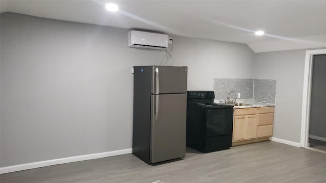 kitchen with a wall mounted air conditioner, light brown cabinets, sink, black range with electric cooktop, and stainless steel refrigerator