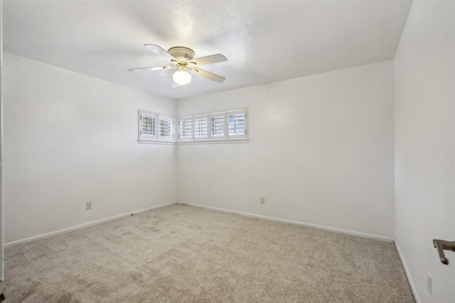 unfurnished room featuring light colored carpet and ceiling fan