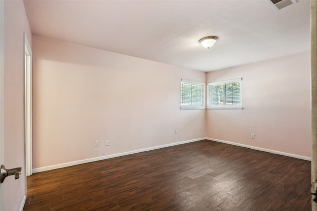 unfurnished room with dark hardwood / wood-style floors