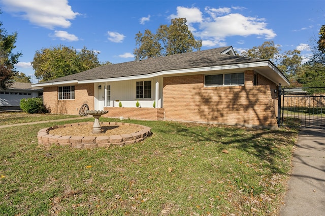 ranch-style home with a front yard and covered porch