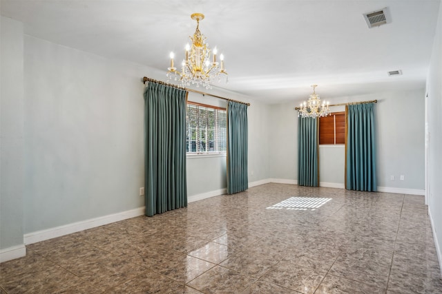 unfurnished room featuring an inviting chandelier