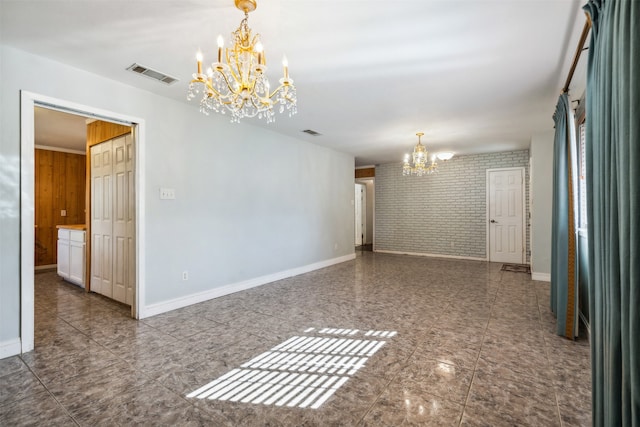 spare room with an inviting chandelier