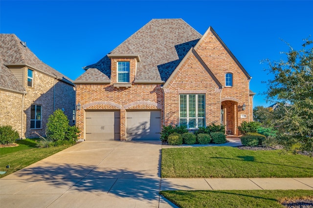 view of front of home featuring a garage and a front yard