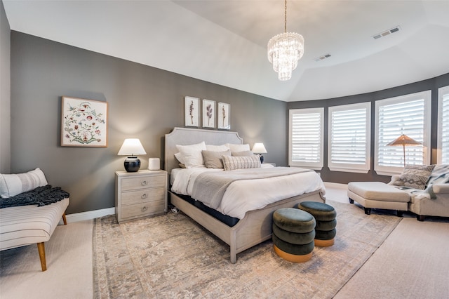 carpeted bedroom with a chandelier and lofted ceiling