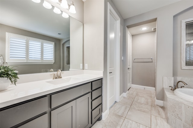 bathroom with vanity and a relaxing tiled tub