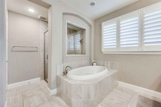 bathroom with tile patterned floors and plus walk in shower