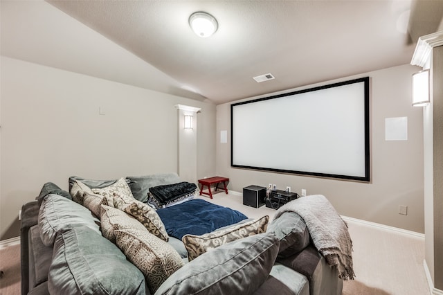 carpeted home theater room featuring lofted ceiling