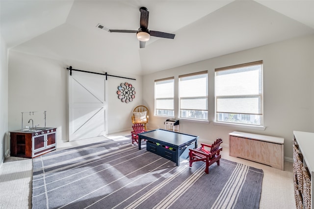 recreation room featuring carpet flooring, a barn door, ceiling fan, and lofted ceiling